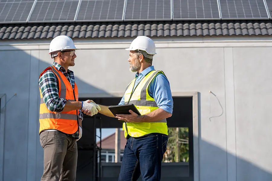 Two men in hardhats at wind energy facility